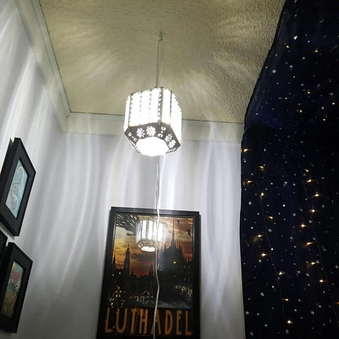 Boho Hanging Plug In Lamp With Dimmable 16.4 Ft Cord Rustic White Crystal Swag Pendant Light illuminates in a cozy room setting.