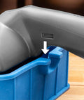 Go-To 5 Inch Wood Glue Roller with thermoplastic rubber roller, silicone rest, ABS handle, close-up of handle resting on blue silicone stand