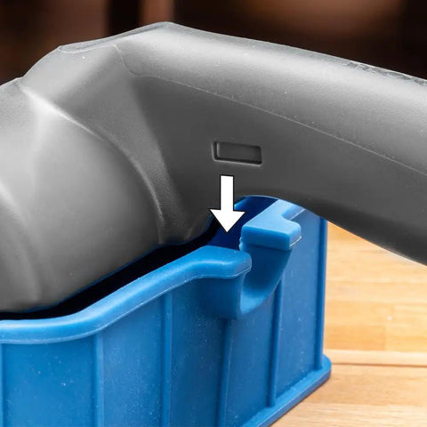 Go-To 5 Inch Wood Glue Roller with thermoplastic rubber roller, silicone rest, ABS handle, close-up of handle resting on blue silicone stand