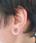 Side view of ear with 10G Clear Silicone Ear Gauges Tunnels Plugs Retainer Set, ultra thin and flexible, fitted in ear lobe.
