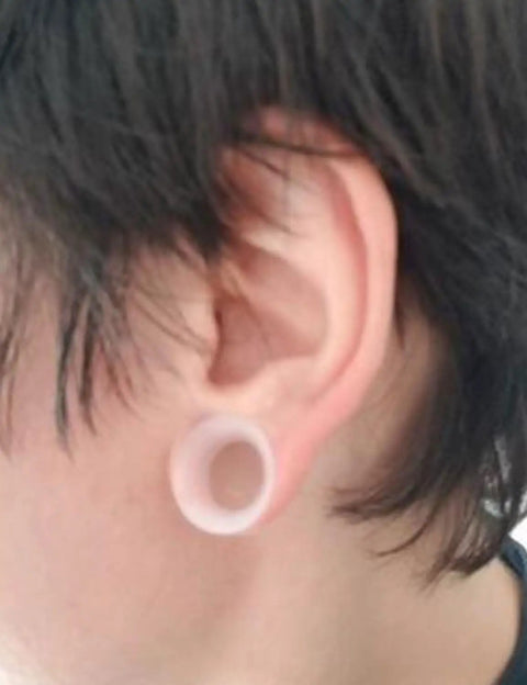 Side view of ear with 10G Clear Silicone Ear Gauges Tunnels Plugs Retainer Set, ultra thin and flexible, fitted in ear lobe.