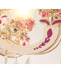 Close-up of Stunning European Crystal Chandelier Featuring Pink Flower Accents Warm Led Ceiling Pendant Light with floral design details.