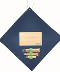 Nomad Camping Kitchen Utensil Kit With Serrated No 12 Folding Knife No 10 Corkscrew Knife No 6 Peeler And Cutting Board shown on fabric