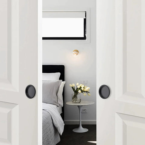 Bedroom scene with white closet doors using 4 Pack Closet Door Finger Pulls For 2-1/8 Inch Holes Stainless Steel Sliding Door Hardware With Easy Snap-In Installation No Nails Needed Durable Finger Pulls For Smooth Closet Door Operation And Quick DIY Replacement, featuring black round handles.