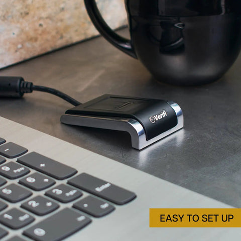 Fast USB Fingerprint Reader For Windows Hello And Passkey Login No Fuss Biometric Security For Your PC With Aluminum Finish In Black And Silver Works With Password Managers And Microsoft Services next to a laptop.