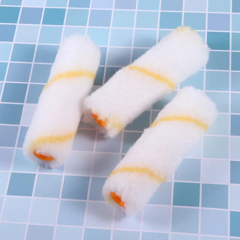 Thirty Mini Paint Roller Sleeves High Density Cotton Refills For Tight Corners Baseboard Trim on a blue grid surface.