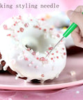 12 Pc Baking Scriber Pens That Nail The Cookie Decor Game With Rust Proof Stainless Steel Cake Icing Needles Serving Straight Fire Pastry Designs For Everyday Bakers, green styling needle used on a decorated donut.