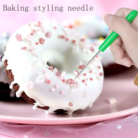 12 Pc Baking Scriber Pens That Nail The Cookie Decor Game With Rust Proof Stainless Steel Cake Icing Needles Serving Straight Fire Pastry Designs For Everyday Bakers, green styling needle used on a decorated donut.
