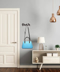 Heavy Duty Cast Iron Wall Mounted Coat Rack For Home Entryway Upgrade Featuring Knockout Build And Modern Vibes To Hang Up Your Gear Without Breaking A Sweat with a blue handbag.