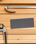 Ultimate 21 Piece Wet Dry Sandpaper Sheets 1500 Grit Emery for Metal Polishing on wood surface with tools.