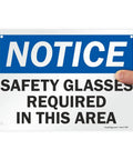 Heads Up Notice Sign Safety Glasses Required In This Area 7x10 Inch Plastic Sign held by hand showing blue and white design