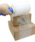 Hand using Industrial Mini Stretch Wrap Film Replacement 5 Inch By 1000 Foot Roll 80 Gauge Heavy Duty Grip Ready Self Adhering Packing Wrap