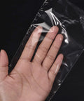 Polyolefin Shrink Wrap Bags 10 X 7 Inch Clear Heat Seal Film 100 Pack held in a hand, showcasing flexibility and clarity.