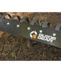Close-up of heavy duty tine plow attachment with 6 bevel-edged spring steel tines, mounted on soil for ATV UTV or truck.