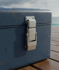 Stainless Steel Spring Toggle Latch 2.8 x 0.7 Inch For Toolboxes And Marine Storage Cases shown on a blue storage box outdoors.