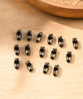 80 Pack Bronze Ball Chain Connectors in 3mm and 3.2mm Sizes with Bronze, Black, and Silver Clips, Durable Metal Fan Pull Chain Connectors for Jewelry, DIY, Crafts on wood surface