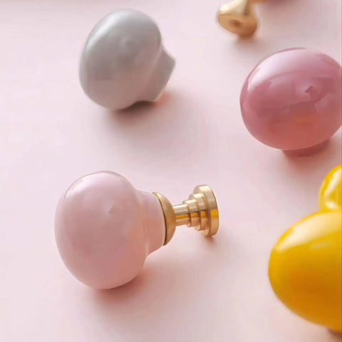 Totally Fresh Ceramic Ball Cabinet Knob Lemon Yellow Single Hole Drawer Pull For Bedroom Dresser And Kitchen Cupboard, shown with pink and gray knobs.