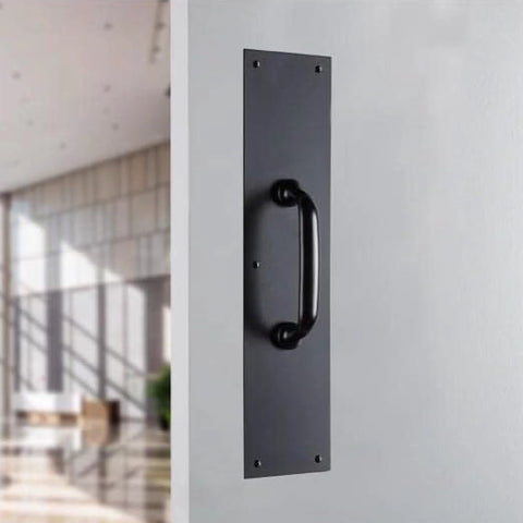 Commercial 15 Inch Stainless Steel Pull Door Plate In Matte Black Finish mounted on a door, pre-drilled for industrial duty entrances.