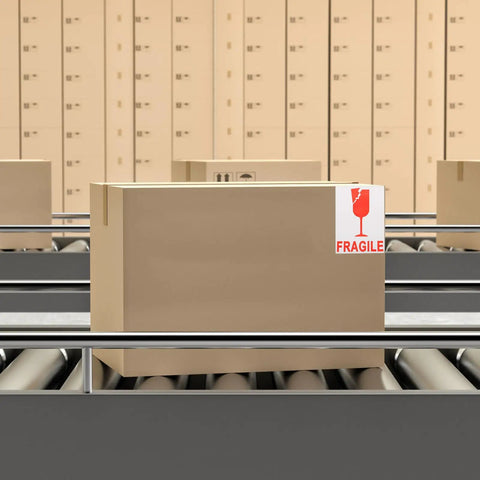 Shipping box with Red Fragile Warning Stickers With Strong Adhesive For Handle With Care Labels on conveyor belt.