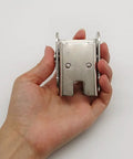 Big League Heavy Duty 90 Degree Folding Self Locking Furniture Hinge In Dark Bronze Galvanized Iron Support Bracket held in hand.