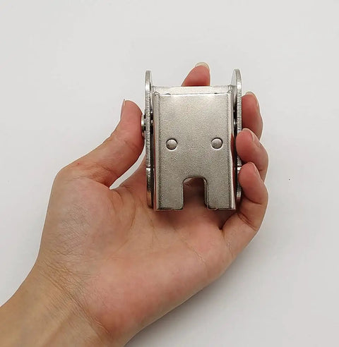 Big League Heavy Duty 90 Degree Folding Self Locking Furniture Hinge In Dark Bronze Galvanized Iron Support Bracket held in hand.