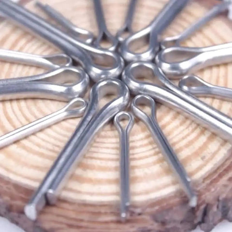 Heavy Duty Split Pin Assortment Kit With 556 Rust Resistant Cotter Pins In Various Sizes For Industrial Machinery And Workshop Projects Inside Large Storage Case, close-up view of assorted galvanized cotter pins arranged on wood.