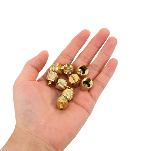 Professional Grade Beefy Brass Refrigeration Valve Caps With Slick Knurled Nozzles For Ac Systems And Coolant Lines Leak Proof Field Service Covers No Sweat Maintenance 30 Pack in hand.
