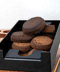 Wooden Espresso Tamping Station and Quick Dump Knock Box with compressed coffee pucks, ideal for 51 to 58mm barista tools.