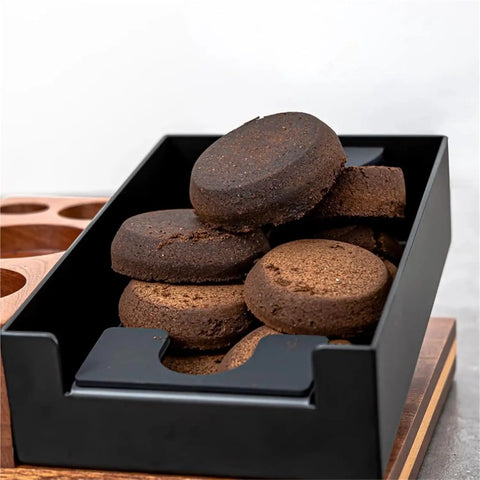 Wooden Espresso Tamping Station and Quick Dump Knock Box with compressed coffee pucks, ideal for 51 to 58mm barista tools.