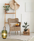 Battery Powered Table Lamp Cordless LED Lantern With Handle Hanging Indoor And Outdoor Light 6 Hour Timer Amber Green Glass Shade Glass And Metal Base For Parties Garden Balcony in cozy living room setup with wicker chair and plants.