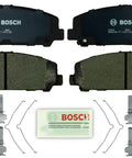 Bosch BP1509 QuietCast organic brake pad set, front view with four pads, hardware, and lubricant packet.