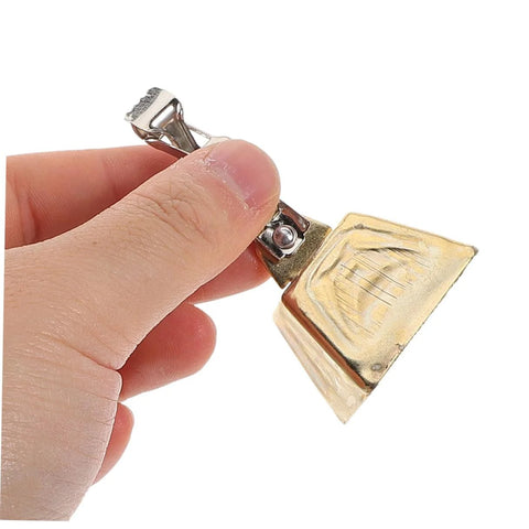 Front view of a stainless steel clip-on fishing bite alarm with brass bell, held by fingers.