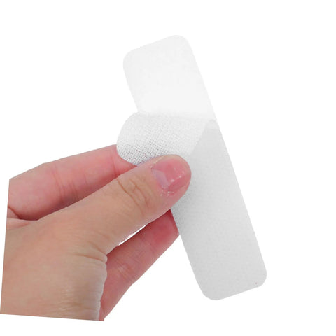 100 Pack Double Sided Hook And Loop Strips With White Pet Film Backing 2.5x10cm Self Adhesive Heavy Duty Fastener Tape For DIY Mounting On Glass Or Metal Walls No Nails Required Strong Hold, being held in hand.