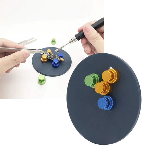 Hands using Magnetic Welding Bracket Soldering Holder For PCB Boards with colored magnets on a metal base.