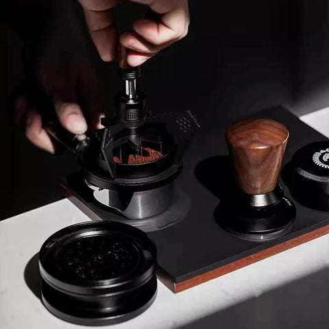 58mm Espresso Needle Distributor Features Nine Fine Thin Needles Adjustable Height Frame And Sleek Black Cleaning Base in use over coffee grounds.