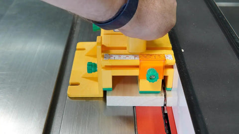 Close-up of a Two Pack 3D Push Block with SafeRip Kit in yellow on a table saw, showing precision and control in woodworking.