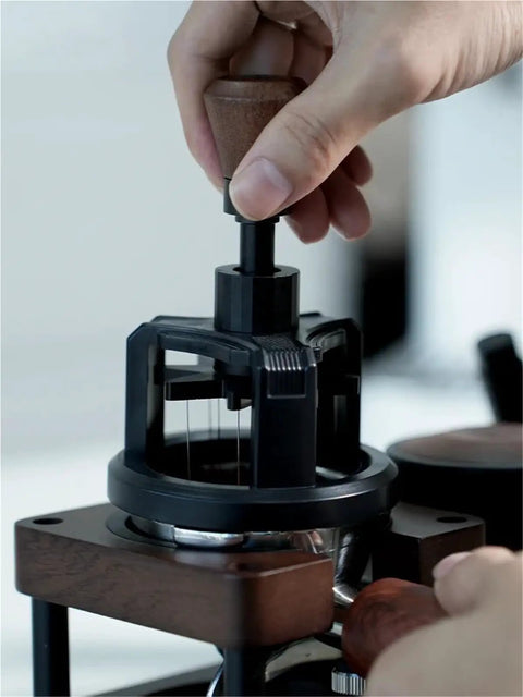 Hit The Mark Every Time With This Rock Solid 58mm Magnetic Stirrer For Espresso Portafilter in use with wooden handle.
