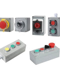 Group of six metal push-button control boxes with color-coded red, green, yellow buttons and protective covers