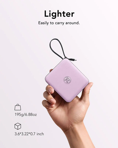 Keep Your Gadgets Juiced 10000mAh Power Bank With Four Built In Cables Fast Charging Portable Battery Pack For Smartphones And Tablets Lightweight Travel Charger In Bold Purple held in hand, showing compact size and design.