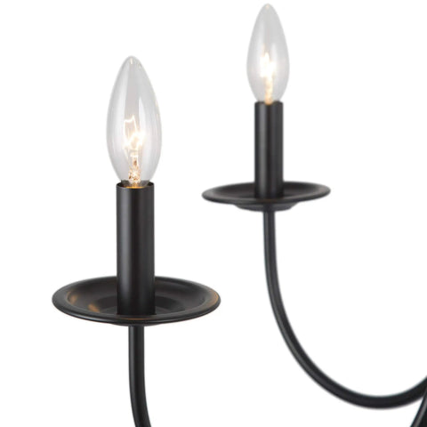 Black Six Light Farmhouse Chandelier With Candle Style Bulbs showing close-up of iron arms and bulbs for modern rustic look
