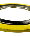 Spiral-wound gasket with yellow outer ring and metal inner ring, front view
