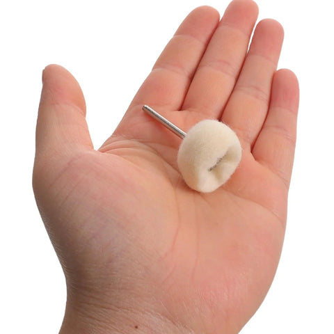Hand holding a single wool polishing buffing wheel from 50 Piece Wool Polishing Buffing Wheels For Drill Attachments With White Cashmere Felt.