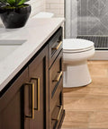 Modern bathroom featuring dark cabinetry with 5 Inch Antique Brass Cabinet Pull Handles, 6 Pack, Grooved Texture Non Slip Grip.