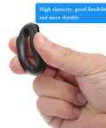 Hand squeezing a 10 Pack Versatile Rubber Grommets 1 Inch ID 25mm Wire Hole Grommets Eyelet Ring Gasket, showcasing elasticity