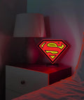Superman Table Lamp And Night Light With Luminescent Halo on bedside table, showcasing 3D S Shield Crest