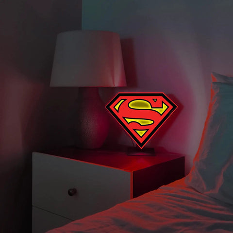 Superman Table Lamp And Night Light With Luminescent Halo on bedside table, showcasing 3D S Shield Crest