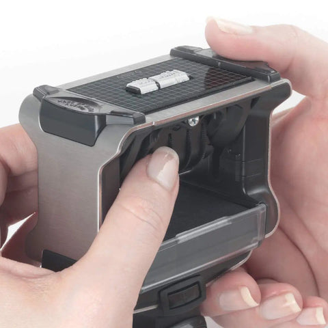 Hands adjusting the Top Shelf Self Inking Date Stamp With Custom Text And Up To Four Lines for easy document stamping.