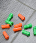50 Pcs Replacement Half Moon Nocks For 7.7mm ID Crossbow Arrows Bolts, green and orange plastic arrow tails on floor