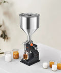 Easy Pull Down Manual Liquid Filler With 10 Liter Hopper And Adjustable 5 To 50 Ml Settings For Smooth Bottling Of Juice Shampoo Honey And Hobby Crafts Built Tough And Reliable on a workbench with various containers.
