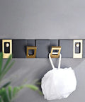 Heavy Duty Nail Free Wall Coat Rack With Sleek Hidden Hooks For Bathroom Bedroom And Entryway Zero Mess Setup Top Tier Organization Sturdy Multi Use Hanging Rack Four Pack mounted on gray wall with a white scrubbing pad.